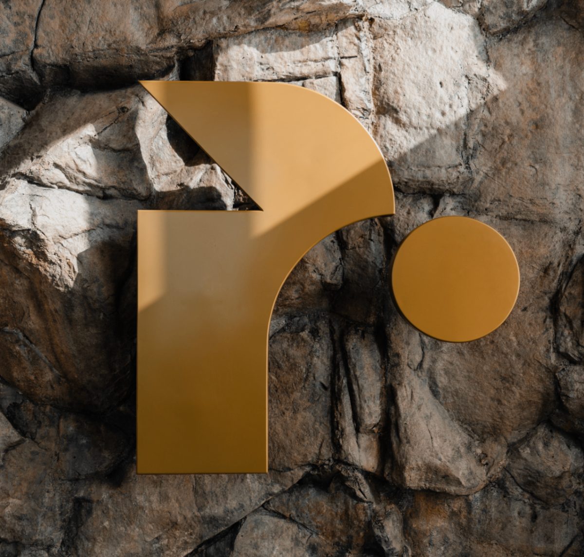 Renegade Reformer brand mark on textured stone wall